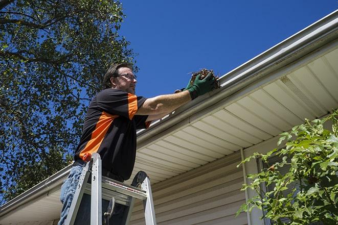 gutter repair specialist inspecting and fixing a damaged section in Berwyn Heights